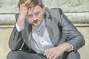 Young handsome businessman in depression. Problems with business. Difficulty, fiction, bankruptcy concept