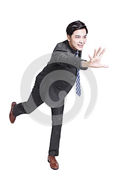 Young handsome businessman running fast and grabbing forward.Isolated on white background
