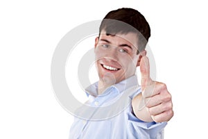 Young handsome businessman shows thumb into camera