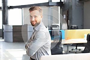 Young handsome businessman smiling in an office environment