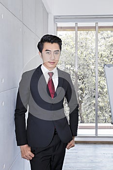 Young handsome businessman smiling and smart at office.He is 20-30 years