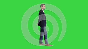 Young handsome businessman standing and waiting on a Green Screen, Chroma Key.