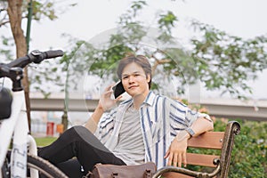 Young handsome businessman talking by mobile phone while sitting