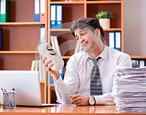 Young handsome businessman unhappy with excessive work