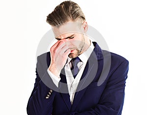 Young and handsome businessman with unhappy face pinch his nose