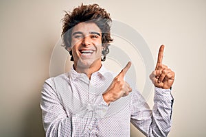 Young handsome businessman wearing elegant shirt standing over isolated white background smiling and looking at the camera