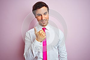 Young handsome businessman wearing shirt and tie standing over isolated pink background doing happy thumbs up gesture with hand