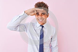 Young handsome businessman wearing shirt and tie standing over isolated pink background very happy and smiling looking far away