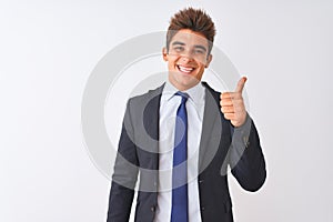 Young handsome businessman wearing suit standing over isolated white background doing happy thumbs up gesture with hand