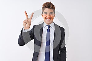 Young handsome businessman wearing suit standing over isolated white background showing and pointing up with fingers number two