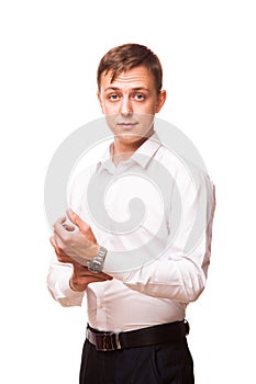 Young handsome businessman in white shirt is standing straight and looking at the camera, portrait isolated on white