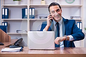 Young handsome businessman working in the office