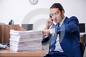 Young handsome businessman working in the office