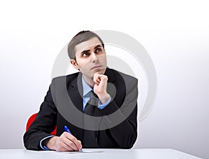 Young handsome businessman writing a letter