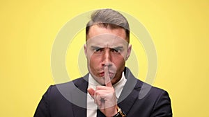 young handsome businessman on yellow background