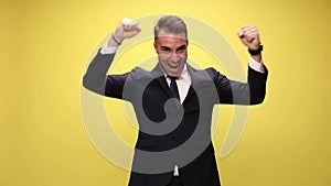 young handsome businessman on yellow background