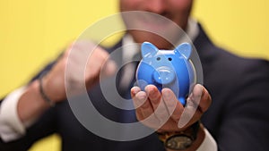 young handsome businessman on yellow background