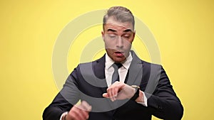 young handsome businessman on yellow background