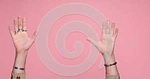 young handsome casual man against pink studio background