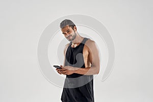 Young handsome caucasian athlete with smartphone