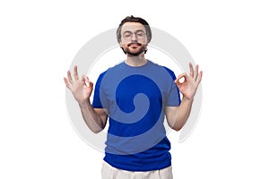 young handsome caucasian man with dark well-groomed hair and beard dressed in a blue t-shirt