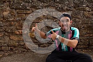 Young handsome caucasian man with dreadlocks wearing casual shirt and glasses smiling positive doing ok sign with hand and fingers