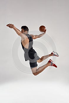 Young handsome caucasian professional male athlete with ball