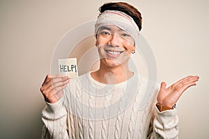 Young handsome chinese man injured for accident wearing bandage on head asking for help very happy and excited, winner expression