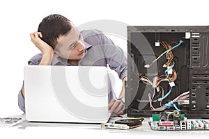 young handsome computer specialist look confuse repairing computer