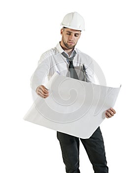 Young handsome construction technician reading drawing plans on white
