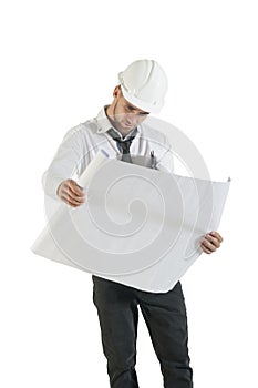 Young handsome construction technician reading drawing plans on white