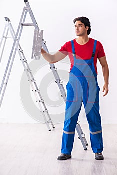 Young handsome contractor working indoors