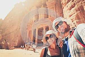 Young handsome couple excited taking selfie in Petra by Treasury landmark. Travelous man and woman, smiling and looking at camera