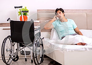 Young handsome disabled man recovering at home