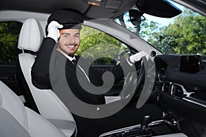 Young handsome driver in luxury car
