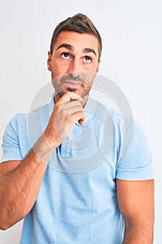 Young handsome elegant man wearing blue t-shirt over isolated background serious face thinking about question, very confused idea