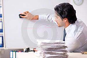 The young handsome financial speciaist in front of white board
