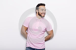 Young handsome fitness man in pink shirt, studio shot.