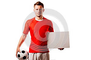 Young handsome football player soccer holds ball and white blank on white.