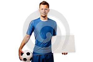 Young handsome football player soccer holds ball and white blank on white.