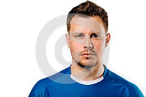 Young handsome football player soccer posing on white isolated background. Blue outfit.