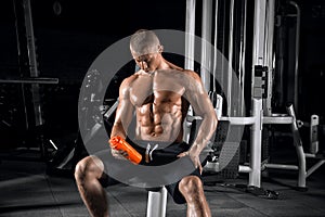 Young handsome guy doing exercises in the gym