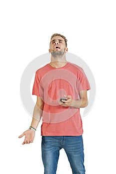 Young handsome guy exasperated by his mobile phone