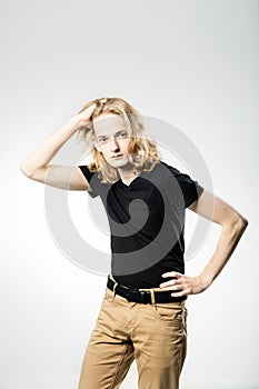 A young handsome guy with long blonde hair, isolated