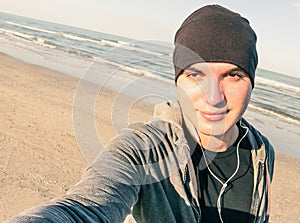 Young handsome guy with male sport clothes taking selfie