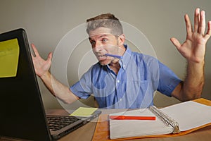 Young handsome and happy business man working with laptop computer at home office gesturing cheerful and excited in entrepreneur s