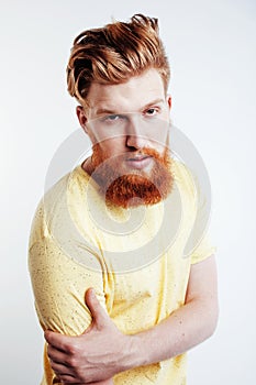 Young handsome hipster ginger bearded guy looking brutal isolated on white background, lifestyle people concept