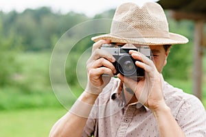 Young, handsome hipster taking pictures outdoors.