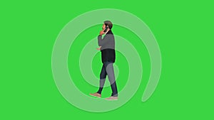 Young handsome hispanic businessman walking and calling on mobile phone on a Green Screen, Chroma Key.
