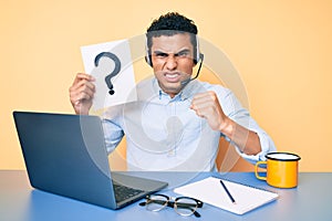 Young handsome hispanic man holding question mark as customer support annoyed and frustrated shouting with anger, yelling crazy